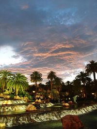 Swimming pool against sky during sunset