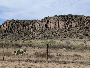 Rock formations on landscape against sky