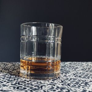 Close-up of drink in glass on table against black background