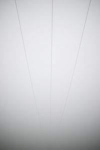 Low angle view of cables against sky