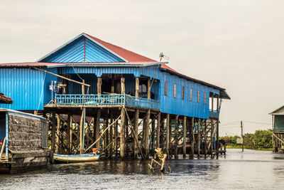 Building by river against sky