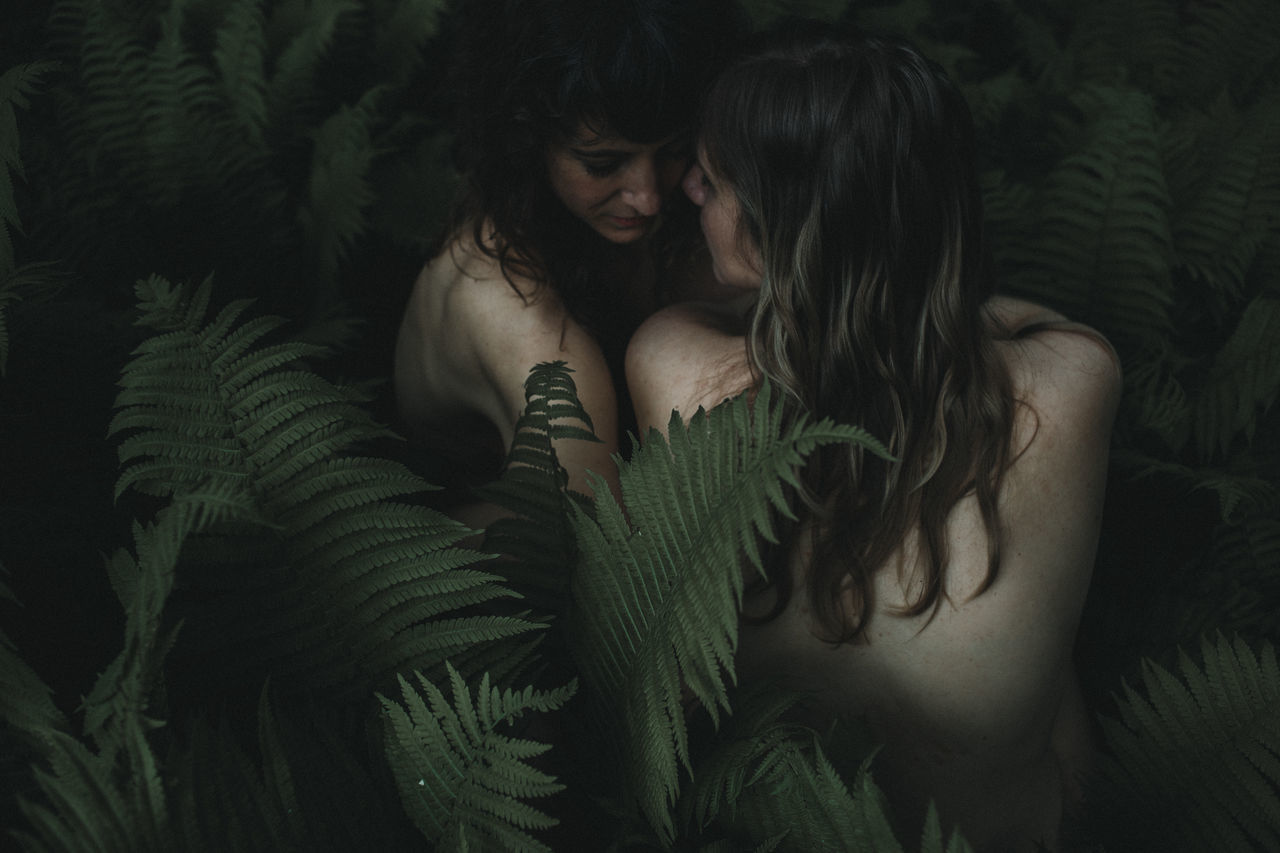 real people, young women, young adult, women, lifestyles, adult, leisure activity, people, long hair, indoors, green color, togetherness, embracing, plant, love, shirtless, positive emotion, hairstyle, beautiful woman, couple - relationship