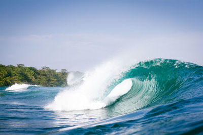 Sea waves flowing against clear sky