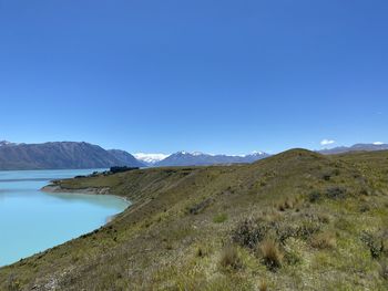 Scenic view of mountains against clear blue sky