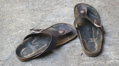 High angle view of slippers on footpath