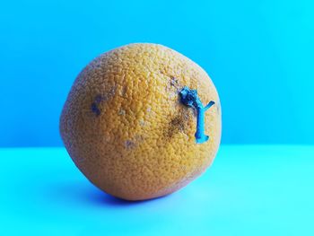 Close-up of apple against blue background