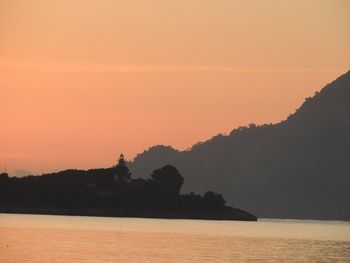 Scenic view of sea against orange sky