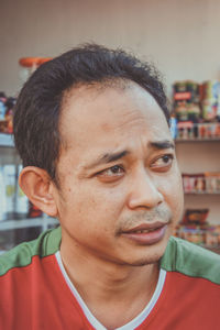 Close-up portrait of young man looking away