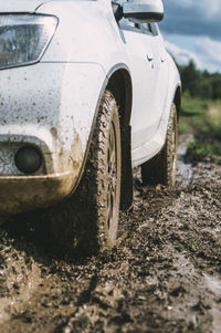 Close-up of car on dirt road