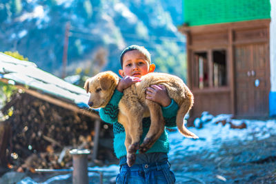 Full length of man with dog standing outdoors