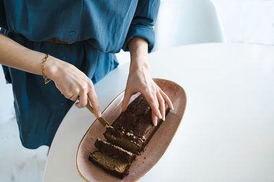 Woman cuts healthy  banana bread 