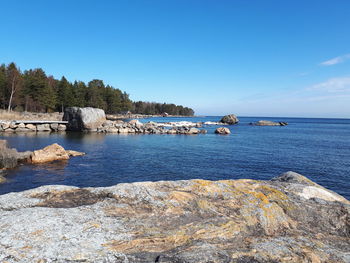 Scenic view of sea against clear blue sky