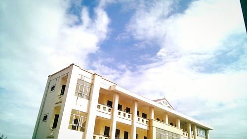 Low angle view of building against cloudy sky