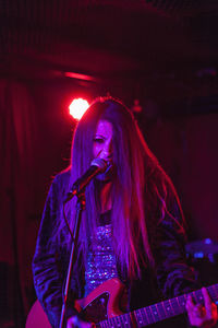 Young woman playing an electric guitar