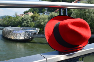 Close-up of red wine in boat against railing