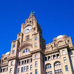 Low angle view of buildings against clear blue sky