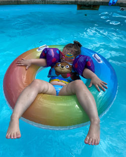 Child floating in swimming in pool