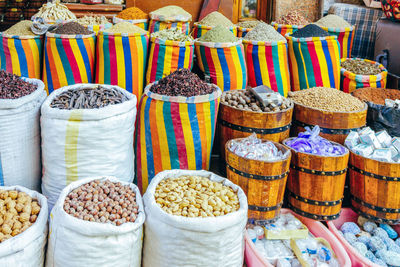 Close-up of various spices and nuts in sack at market stall