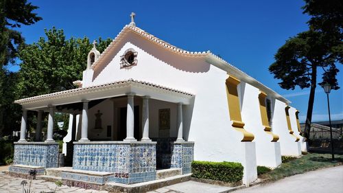 Low angle view of building against clear blue sky