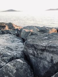 Rocks on beach against sky