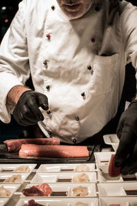 Midsection of chef serving food