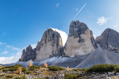 Scenic view of rocky mountains against blue sky