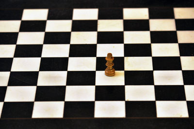 High angle view of chess piece on checked board