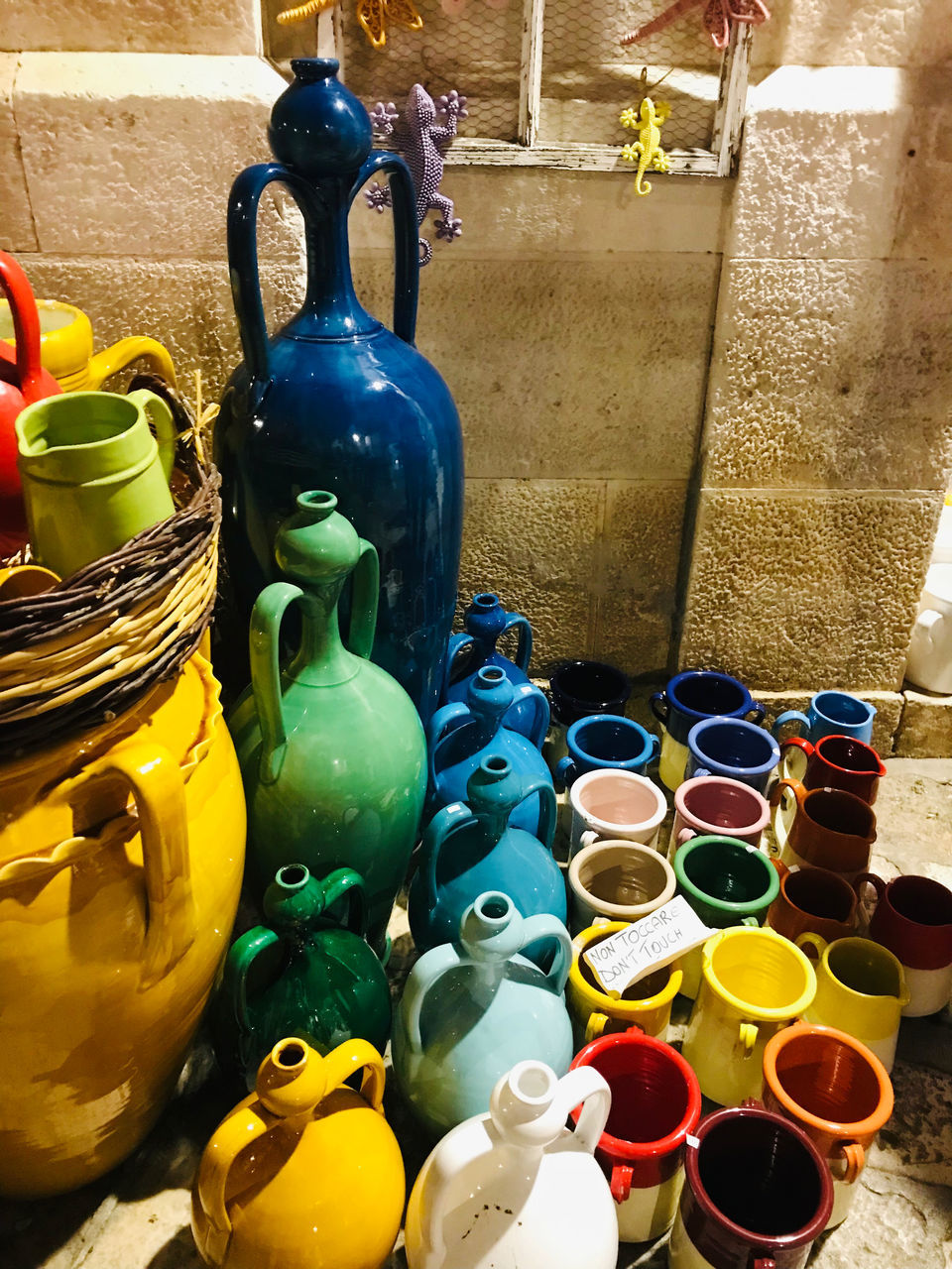 multi colored, large group of objects, container, yellow, variation, no people, art, still life, ceramic, craft, retail, pottery, market, abundance, for sale, tableware, indoors, business, jug, vase