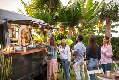 Queue of diverse people to food truck