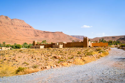 Scenic view of desert against blue sky