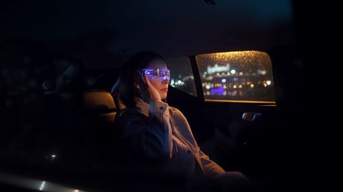 Fashion cyberpunk business woman wearing vr glasses and drive car
