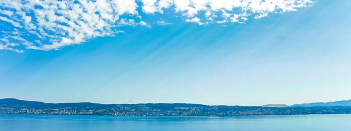 Scenic view of sea against blue sky