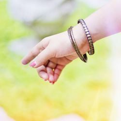 Cropped hand of girl gesturing outdoors