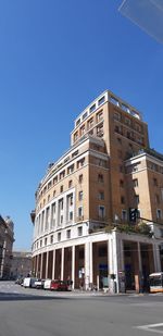 Low angle view of building against clear blue sky