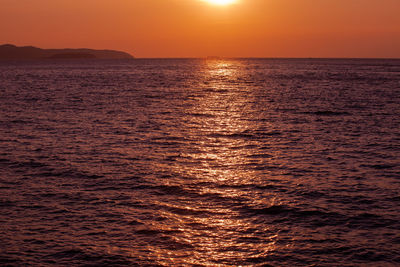 Scenic view of sea against orange sky