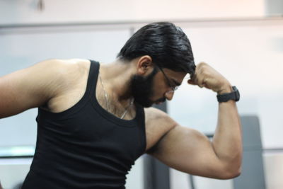 Man flexing muscles at gym