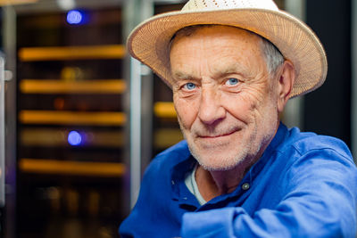 Close-up portrait of senior man wearing hat