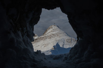 Low angle view of mountain against cloudy sky