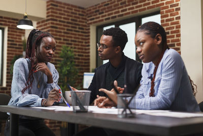 Side view of business colleagues working at office