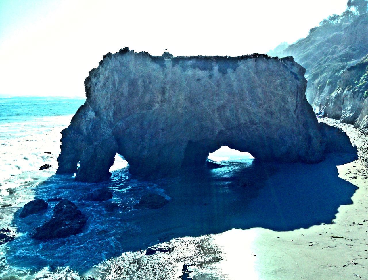 sea, water, rock formation, beach, rock - object, tranquility, beauty in nature, tranquil scene, scenics, horizon over water, nature, shore, rock, blue, cliff, sand, clear sky, idyllic, sky, day