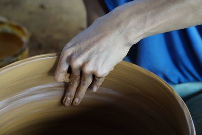 Close-up of hand making pot