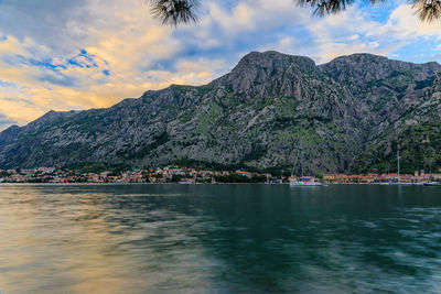 Scenic view of lake and mountains against sky during sunset