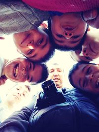 Directly below view of man with digital camera amidst boys