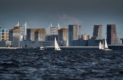 Boats in sea against clear sky