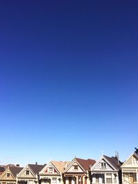 High section of houses against clear blue sky