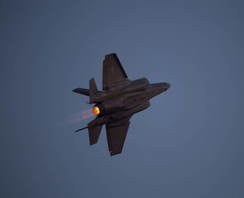 Low angle view of airplane flying against clear sky