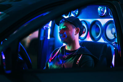 Portrait of young man on tuning car