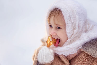 Cute girl eating food during winter