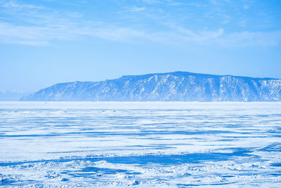 Scenic view of snowcapped mountains against blue sky