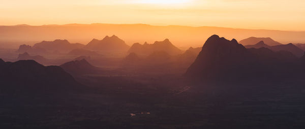 Scenic view of silhouette mountains against sky during sunset